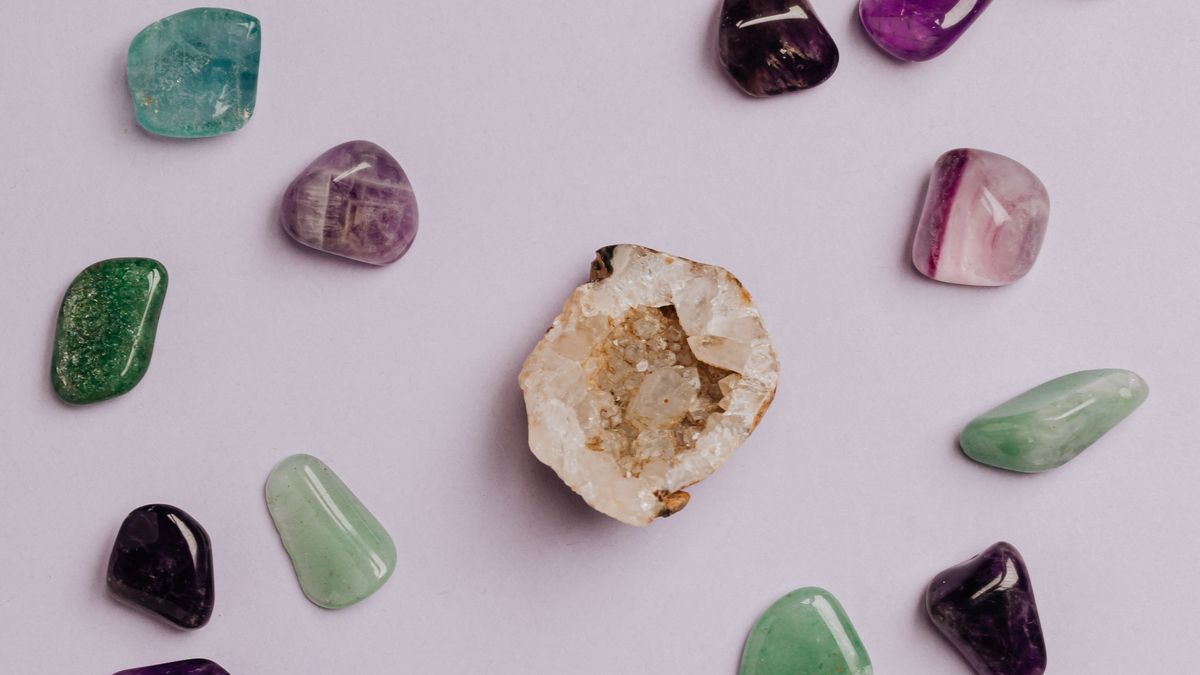 Colourful polished gemstones arranged on a neutral surface