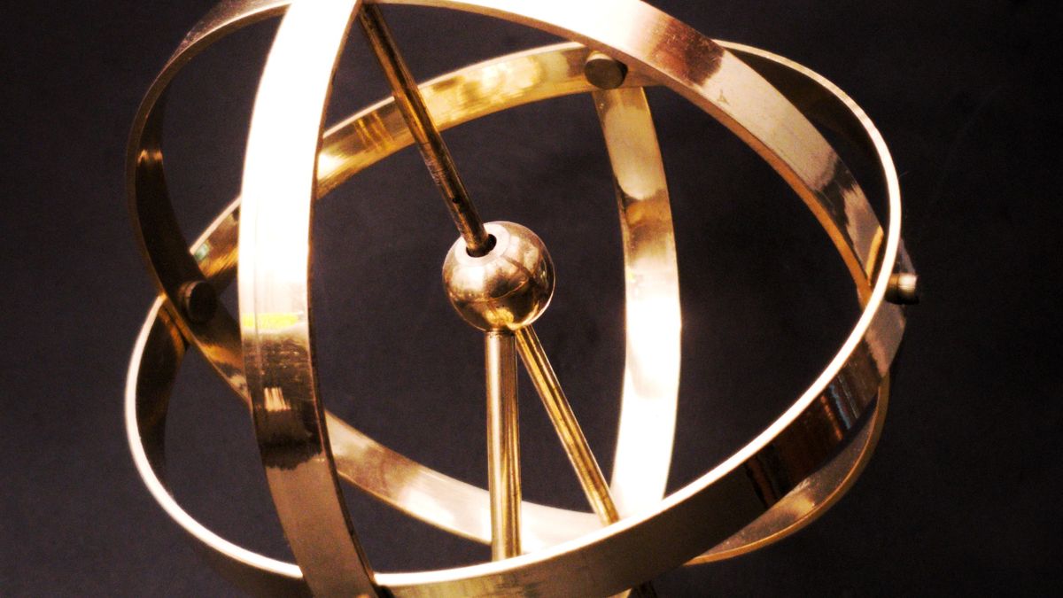 Brass armillary sphere on a marble base, symbolising the moment a KP horary question is asked