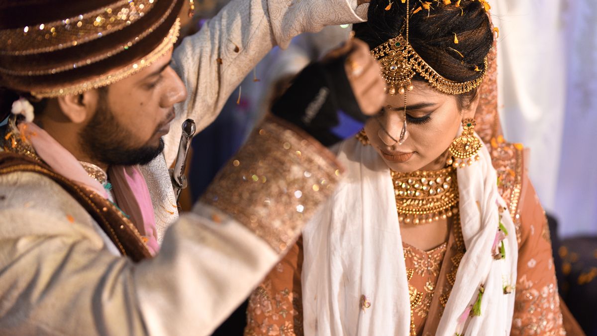 Traditional Indian wedding ceremony with bride and groom exchanging rituals